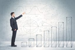 Business man climbing up on hand drawn graphs concept on background